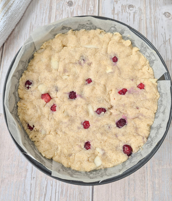Step 7 – Apple cranberry cake batter spread in cake tin ready for topping