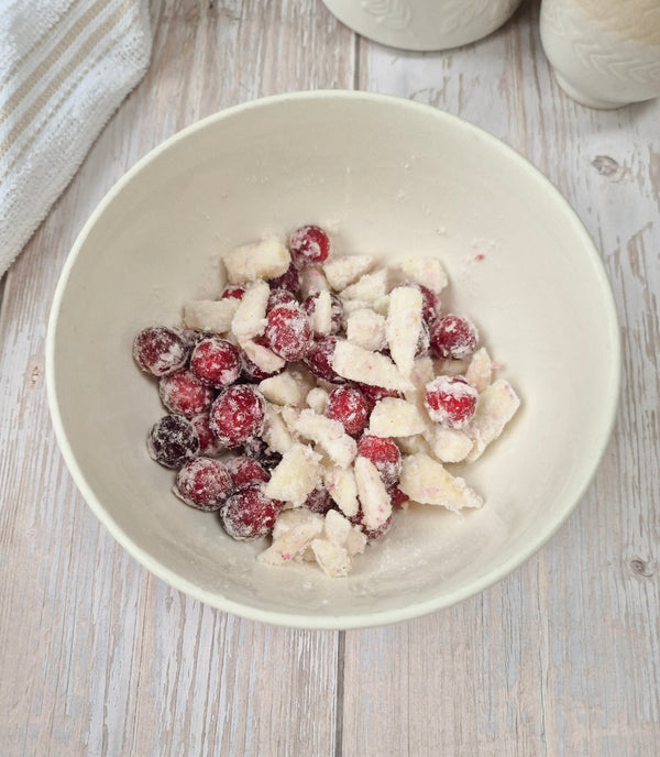 Step 4 – Coating cranberries and apple pieces before adding them to the cake batter