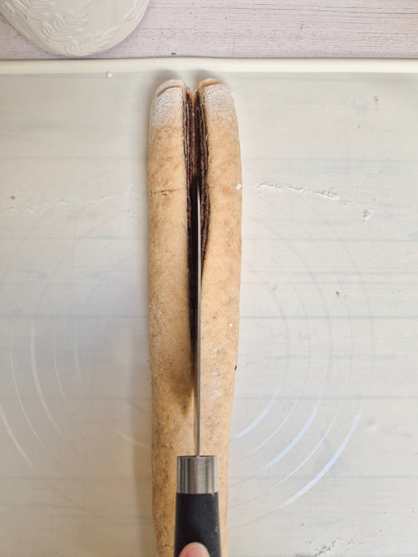 Step 11 – Cutting babka dough log lengthwise to create the swirl layers