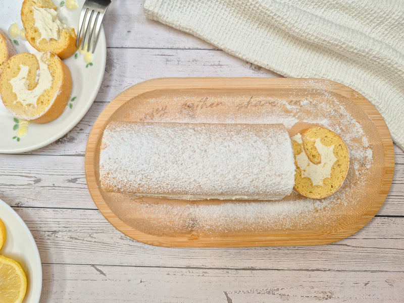 Gluten-free lemon Swiss roll with creamy filling sliced on a serving board made with ReWild CoreBake