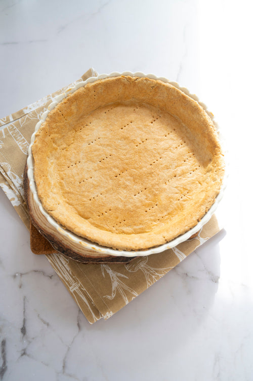 Baked low-carb gluten-free pie crust made with ReWild CoreBake in a pie dish
