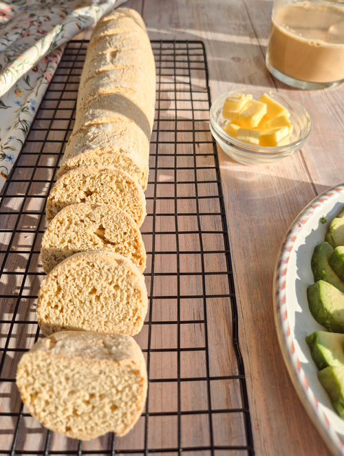 Sliced low-carb gluten-free bread loaf cooling on a rack made with ReWild CoreBake
