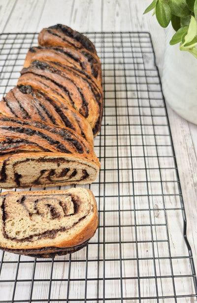 Low-carb gluten-free chocolate babka loaf sliced on a cooling rack made with ReWild CoreBake