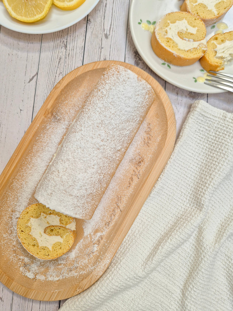 Low-carb gluten-free lemon Swiss roll sliced and dusted with sweetener made with ReWild CoreBake