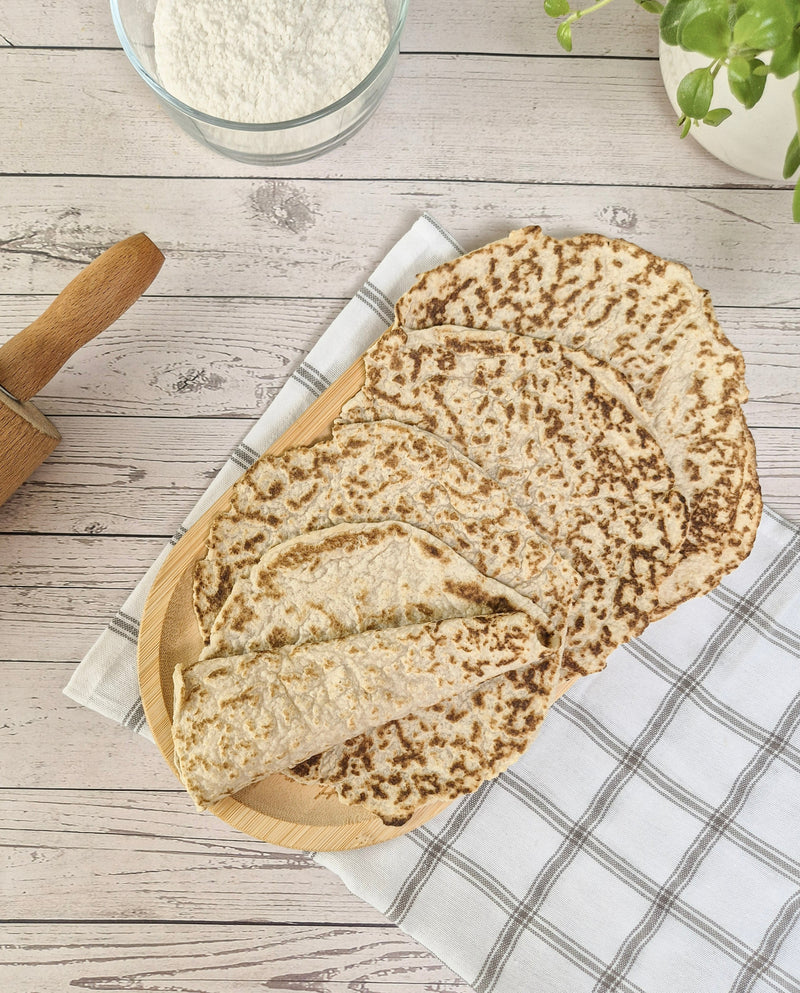 Low-carb gluten-free wraps stacked on a board made with ReWild CoreBake