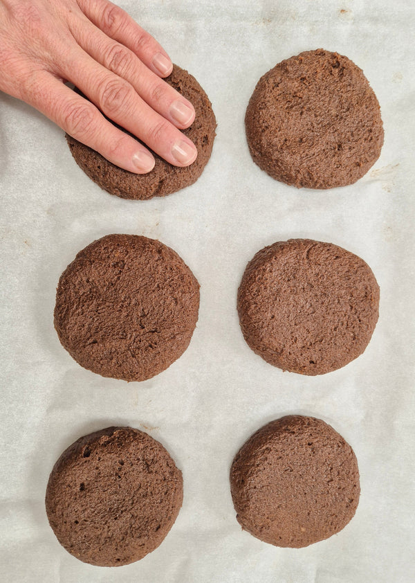 Step 3 – Shaping soft cacao cookie dough into round cookies before baking