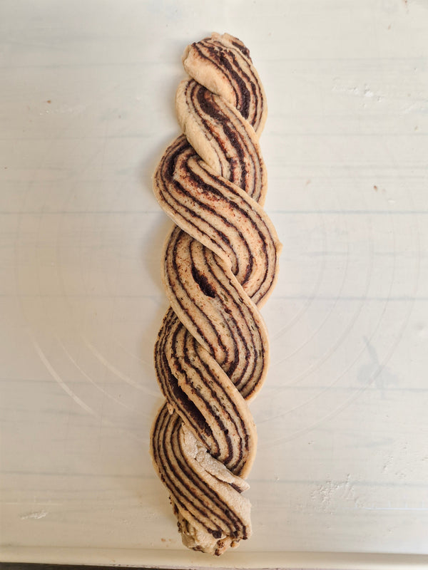 Step 12 – Twisting gluten-free babka dough strands to form the braided loaf